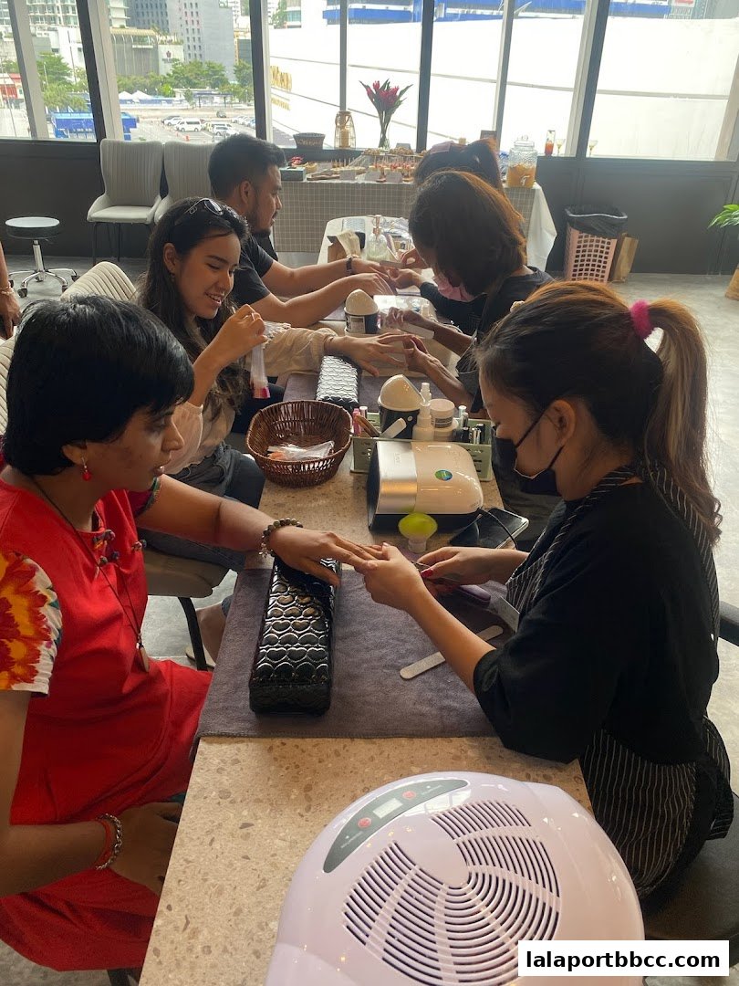 People getting manicures and pedicures at a bright, modern nail salon.