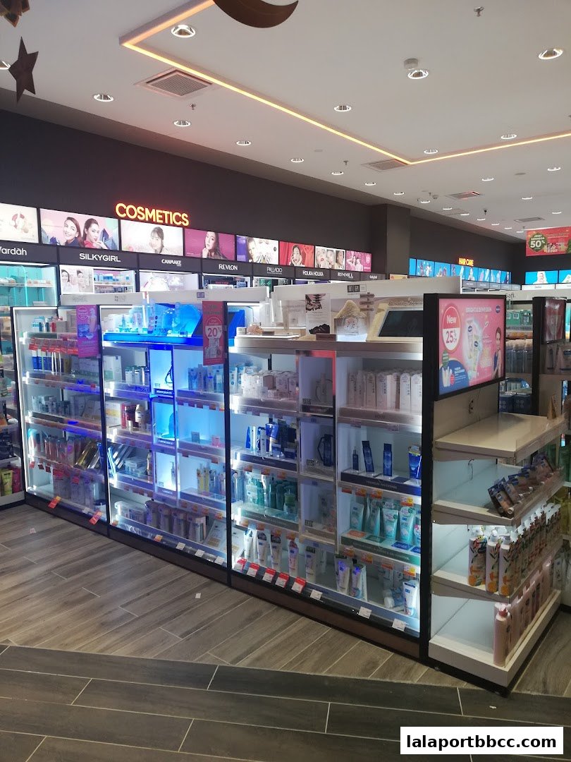 Interior view of a Guardian store showcasing cosmetics and hair care products on illuminated shelves.