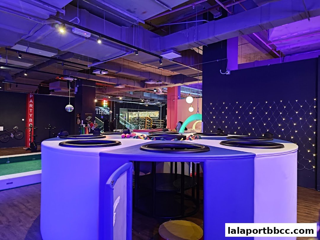 Interior of PartyBox 360 with interactive games and colorful lighting.