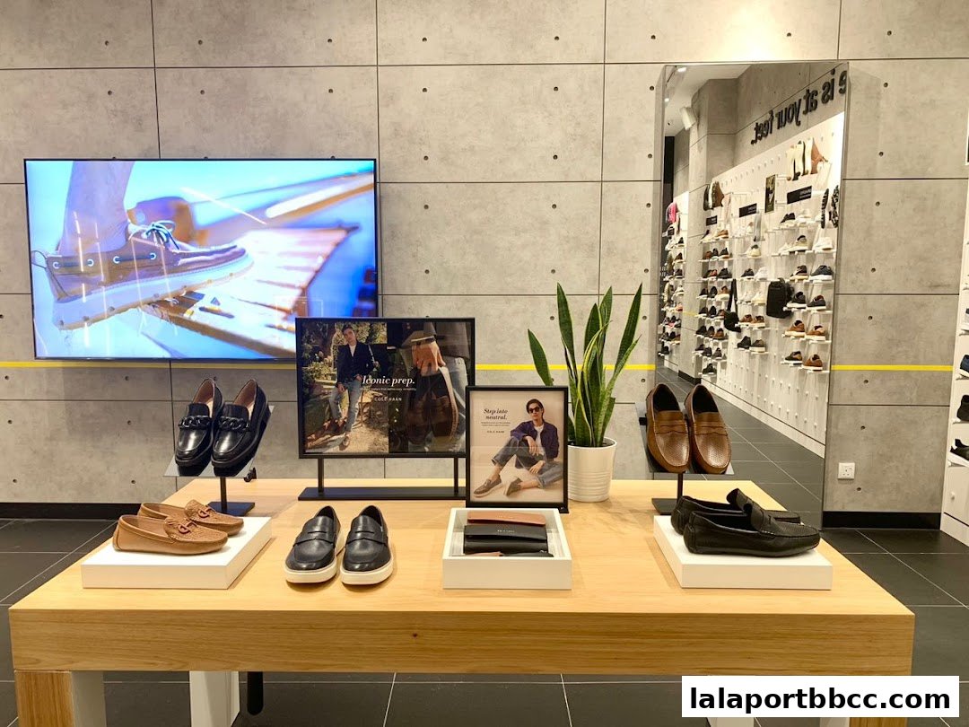 Cole Haan store interior showcasing various men's loafers and dress shoes on display.