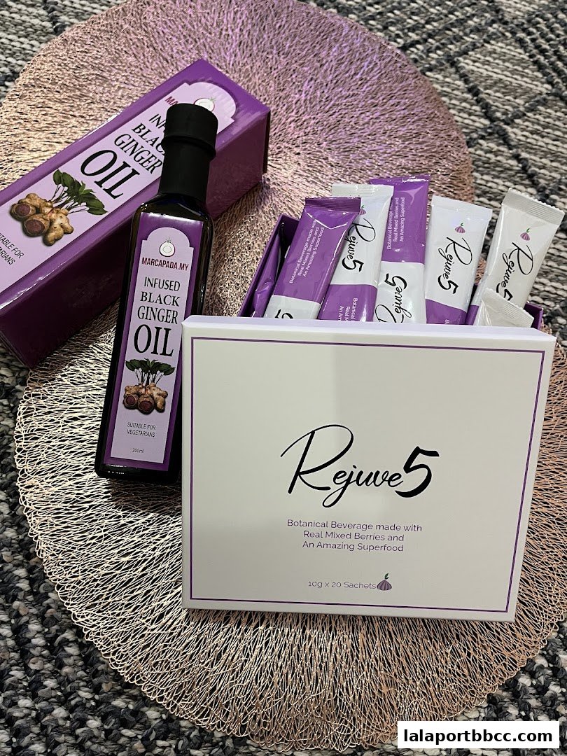 A bottle of infused black ginger oil and a box of Rejuve5 botanical beverage sachets.