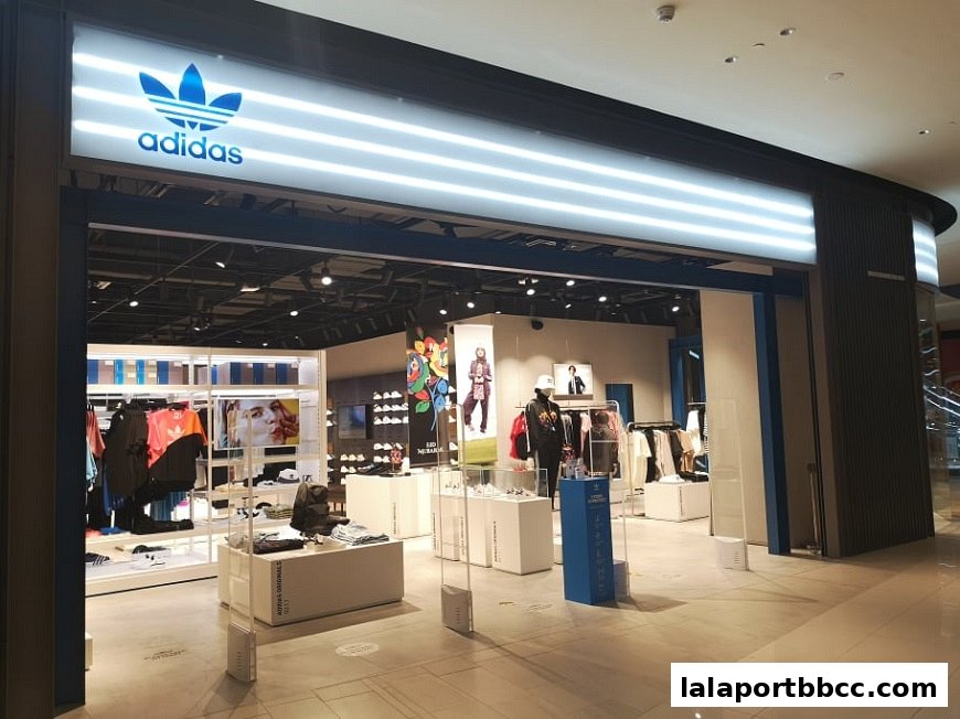 The exterior of an Adidas Originals store with clothing displays and signage.