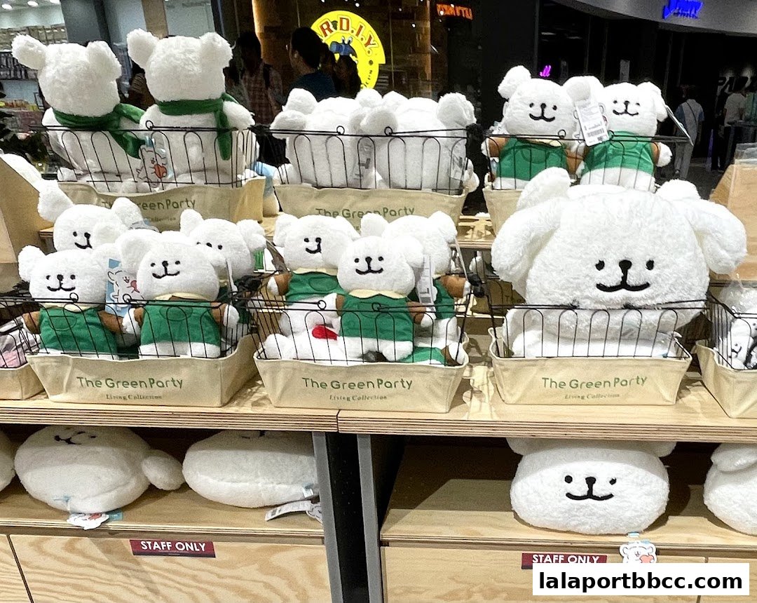 A display of cute, fluffy white stuffed animals with black eyes and smiles.