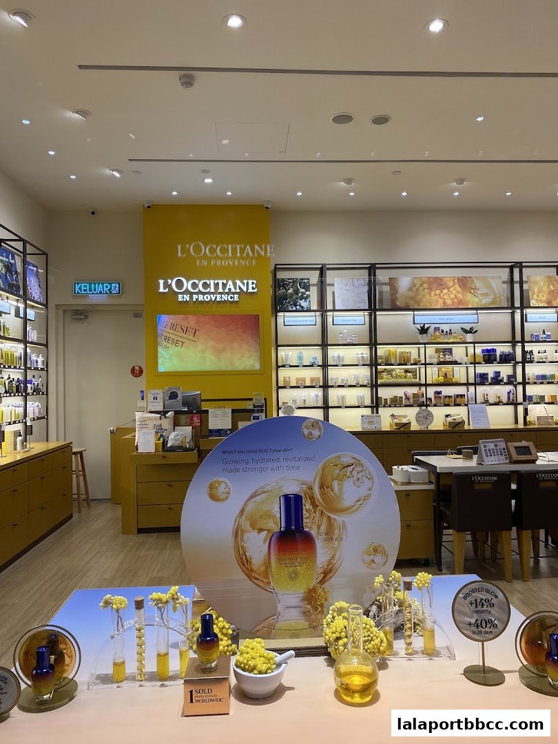 Interior view of a L'Occitane store showcasing skincare products and promotional displays.