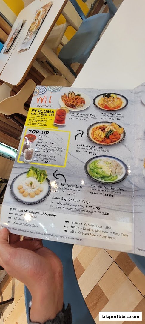 A menu from Mi Noodles restaurant showcasing various noodle dishes and drinks.