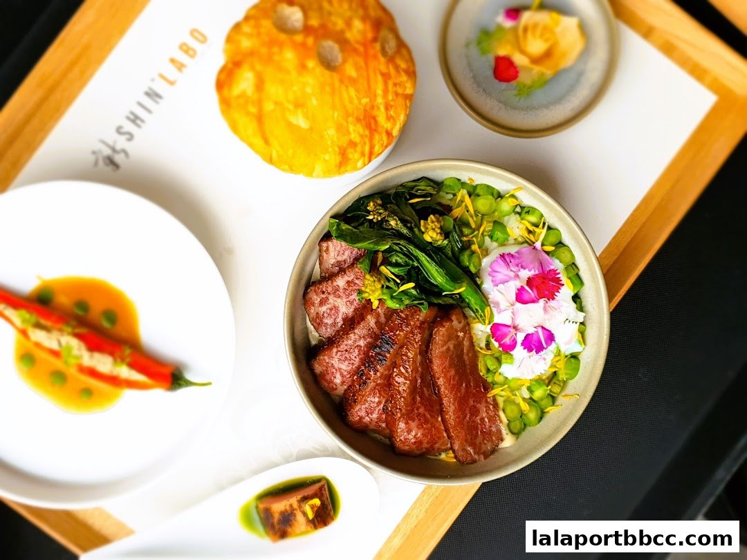 A beautifully presented meal with steak, vegetables, and chili peppers on a tray.