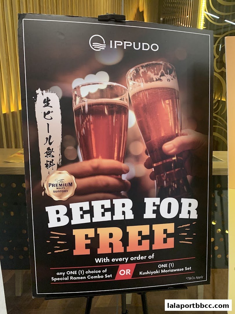 A promotional poster for IPPUDO offering free beer with specific set orders.