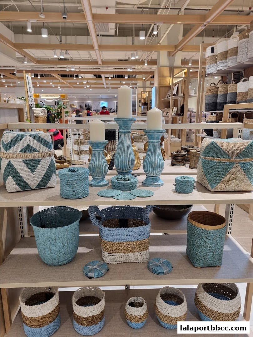 A display of decorative baskets and candle holders on shelves in a retail store.