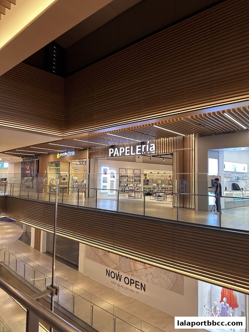 The Papeleria shop front with its name illuminated and displays of stationery inside.