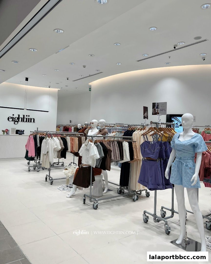 Interior view of Eightiin Fashion store showcasing clothing racks and mannequins with stylish apparel.