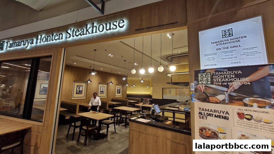 The exterior and interior of Tamaruya Honten Steakhouse, showing seating and a menu board.
