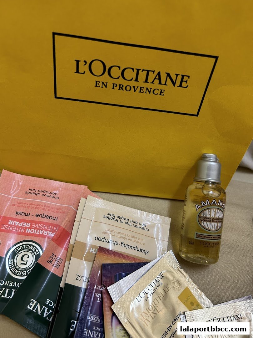 A collection of L'Occitane skincare samples and a small shower oil bottle.