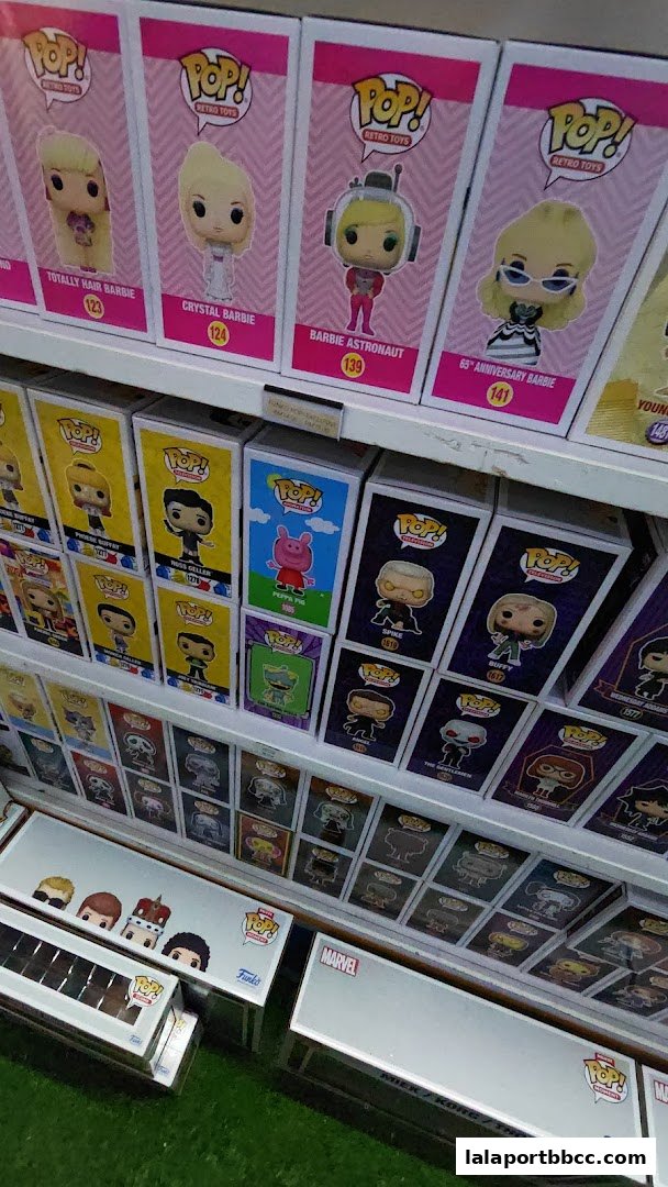 Shelves filled with collectible Funko Pop! figures, including Barbie and other pop culture characters.