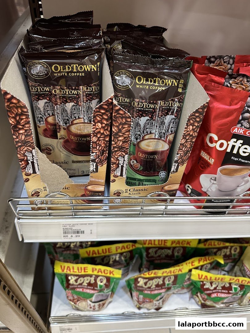 A shelf displaying various brands of instant coffee, including OldTown White Coffee and Kopi O.