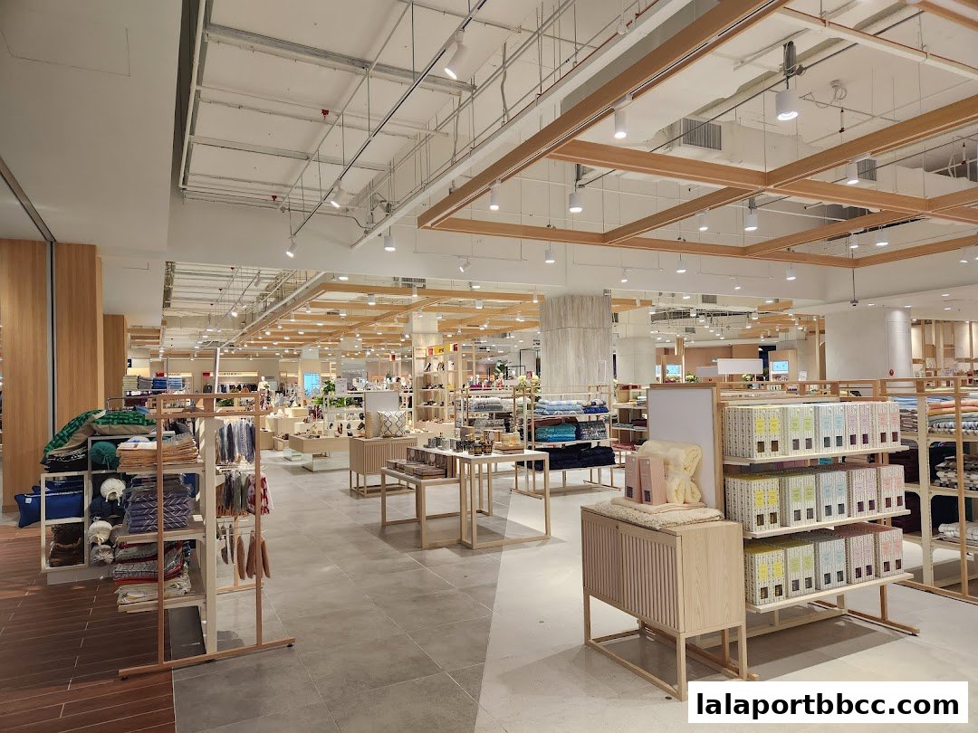 Interior view of a well-lit department store with various merchandise displayed on shelves and racks.