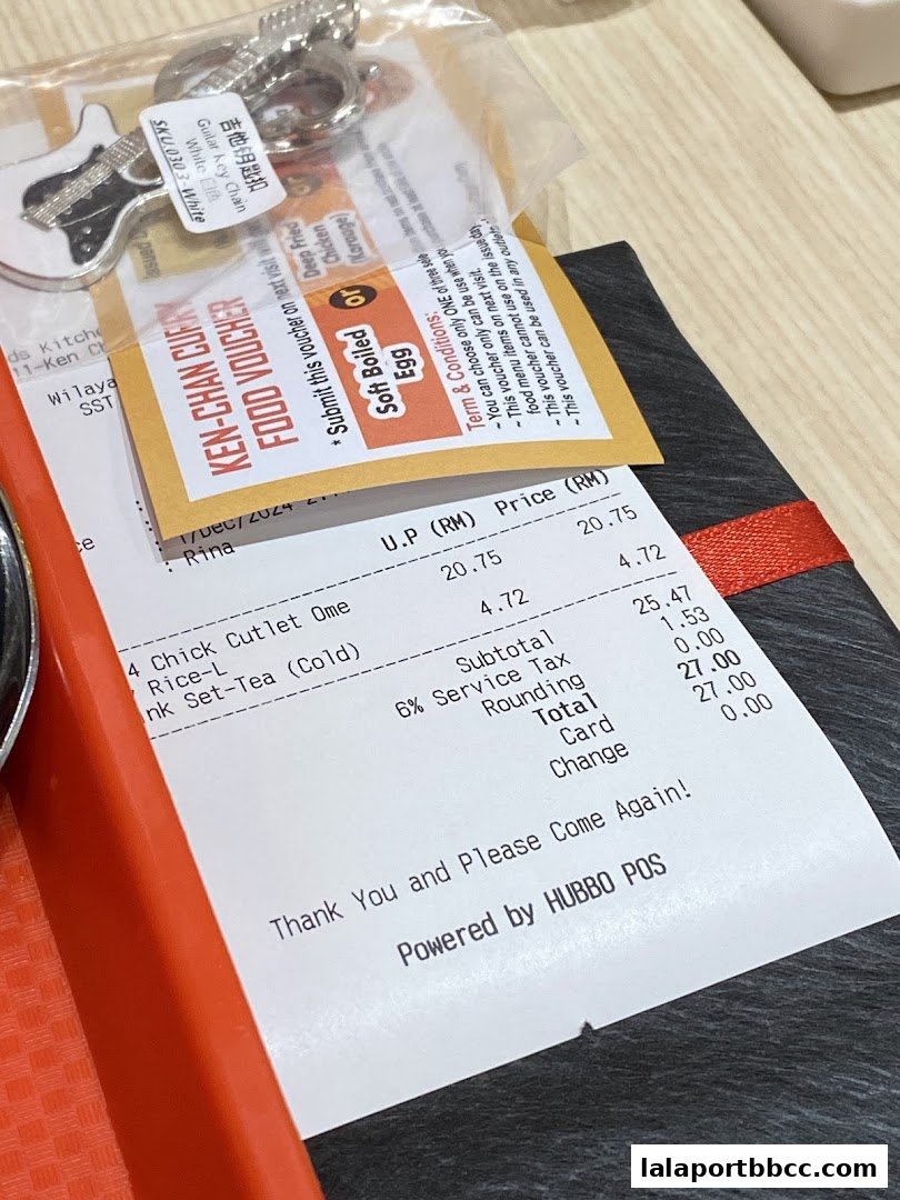 A receipt and food voucher from Ken-Chan Curry with a guitar keychain.