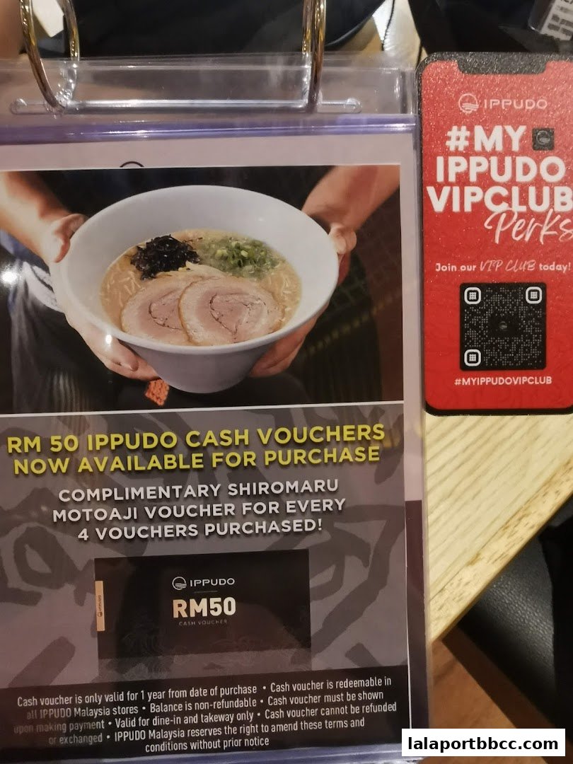 A display promoting RM50 Ippudo cash vouchers and a VIP club with a QR code.