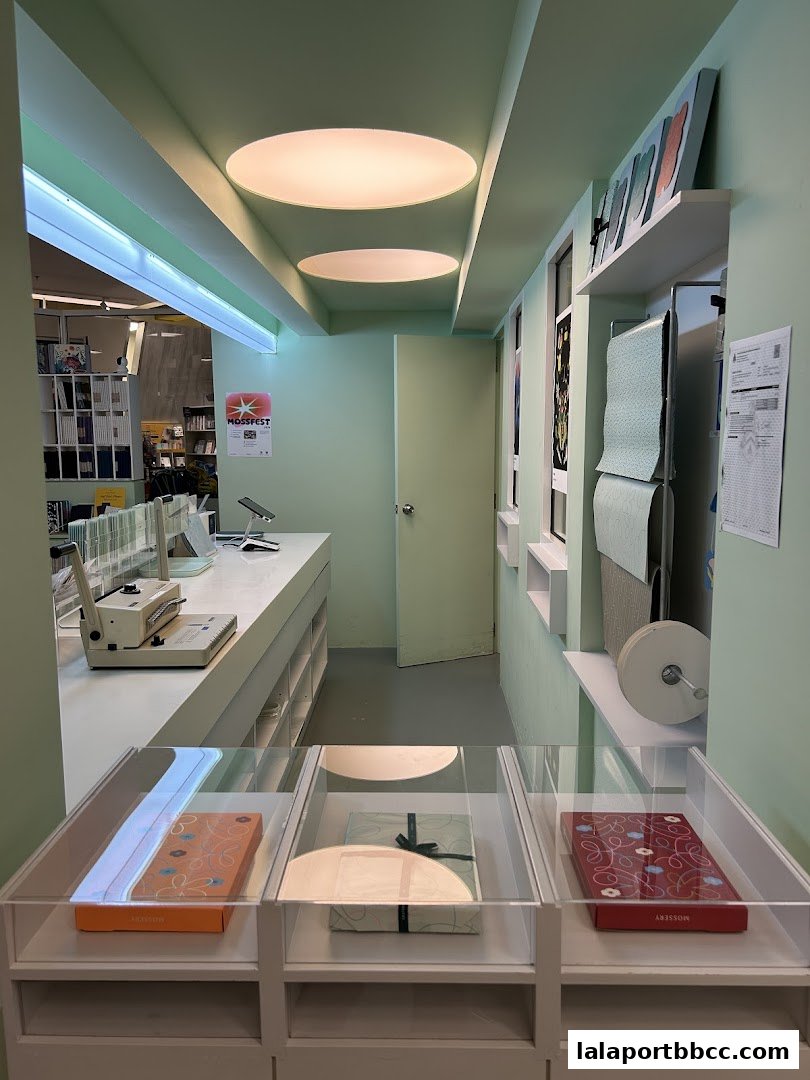 Interior view of a shop with display cases, a counter, and shelves with products.