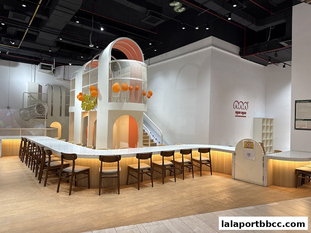 Interior of a modern, spacious play area with a long counter and seating.
