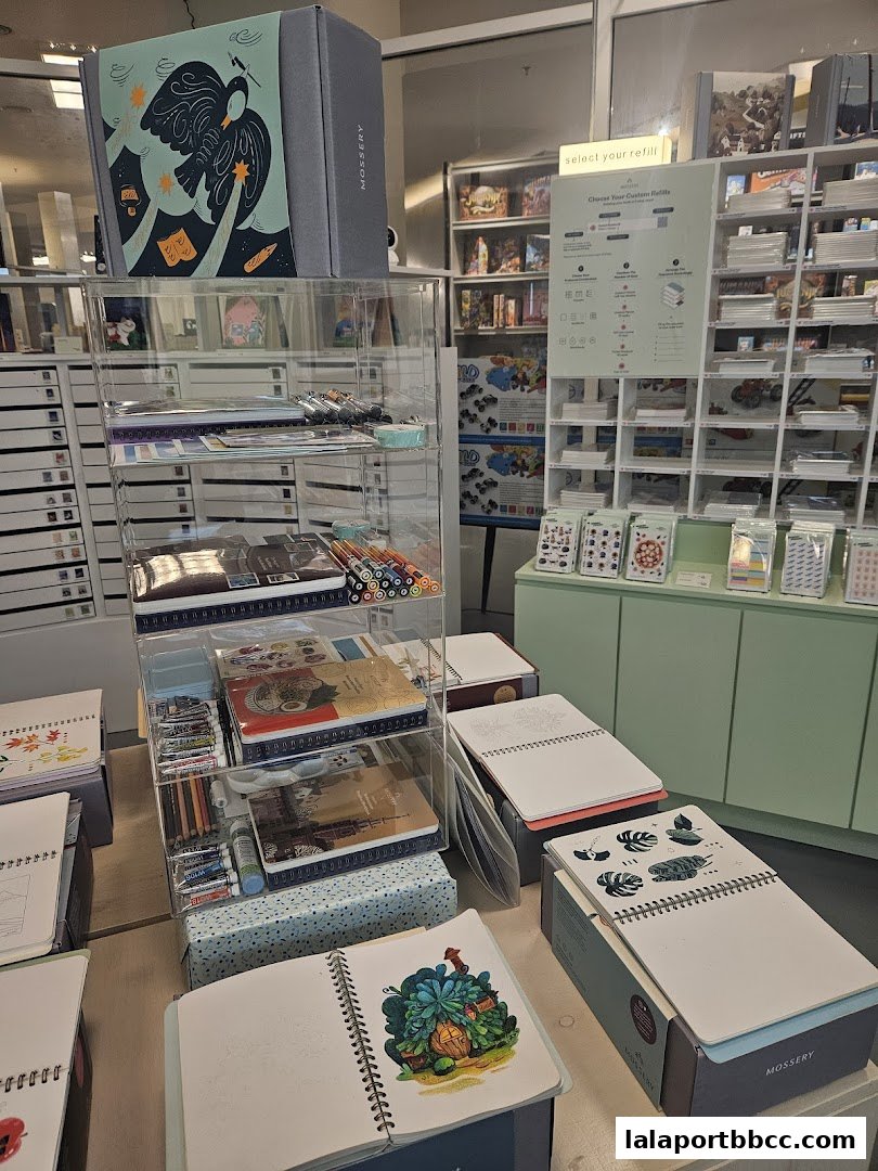 A display of notebooks, art supplies, and stationery products in a retail store.