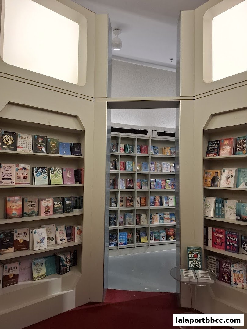 Interior view of a bookstore with shelves full of books and a red carpet.