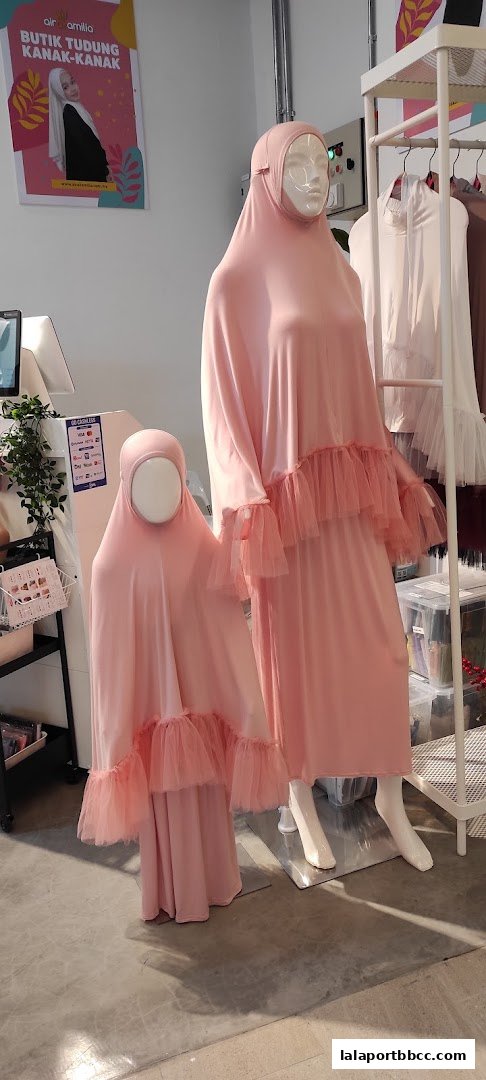 Mannequins display matching pink modest wear with tulle detailing for mother and child.