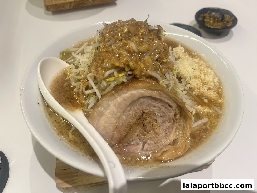 A close-up shot of a delicious bowl of ramen with a large slice of chashu pork.