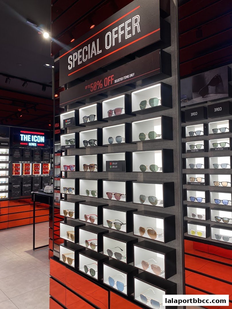 A display of various sunglasses in a retail store with a special offer sign.
