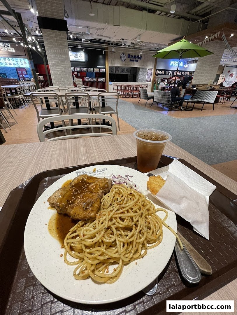 A plate of spaghetti with steak and a drink at Sunny Apes.