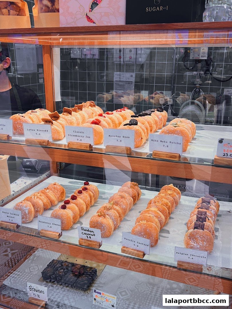 A display case filled with various donuts and brownies at Sugar and I.