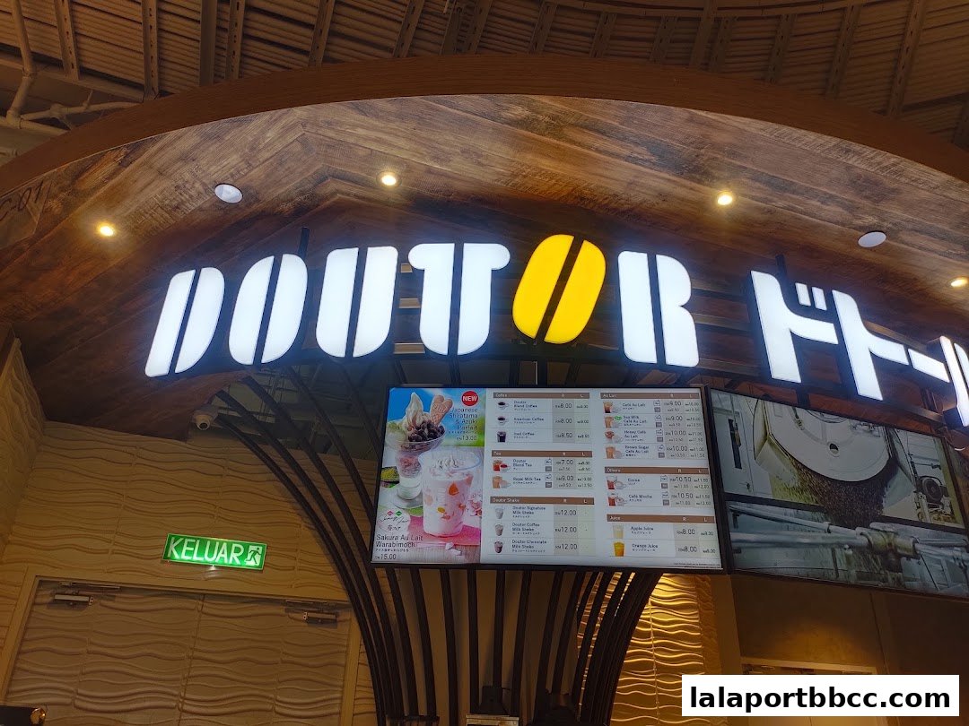 The illuminated sign of DOUTOR COFFEE with a digital menu displaying various drinks and desserts.