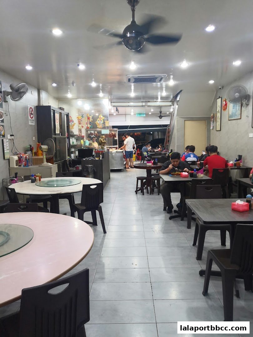 Interior view of Restoran Teo Chew with diners seated at tables and staff working.