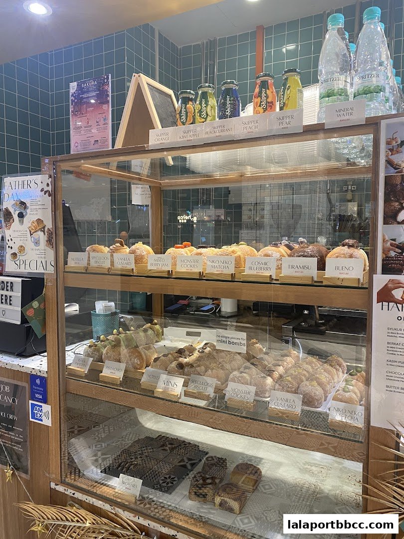 A display case filled with various pastries and drinks at a bakery.