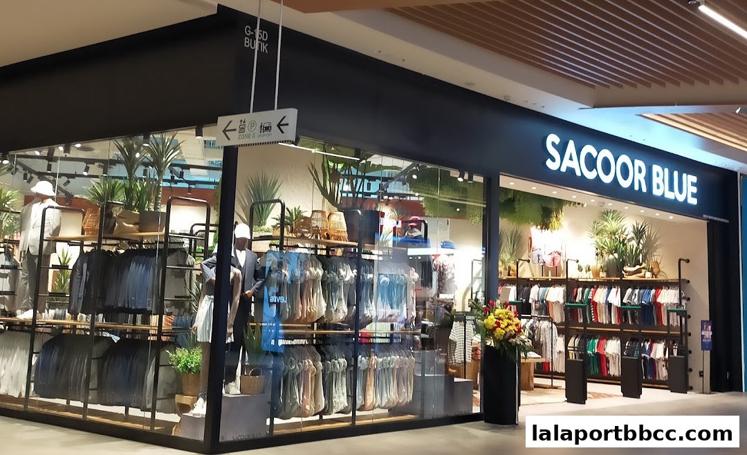 The Sacoor Blue store features a modern facade with mannequins and a wide selection of clothing displayed.