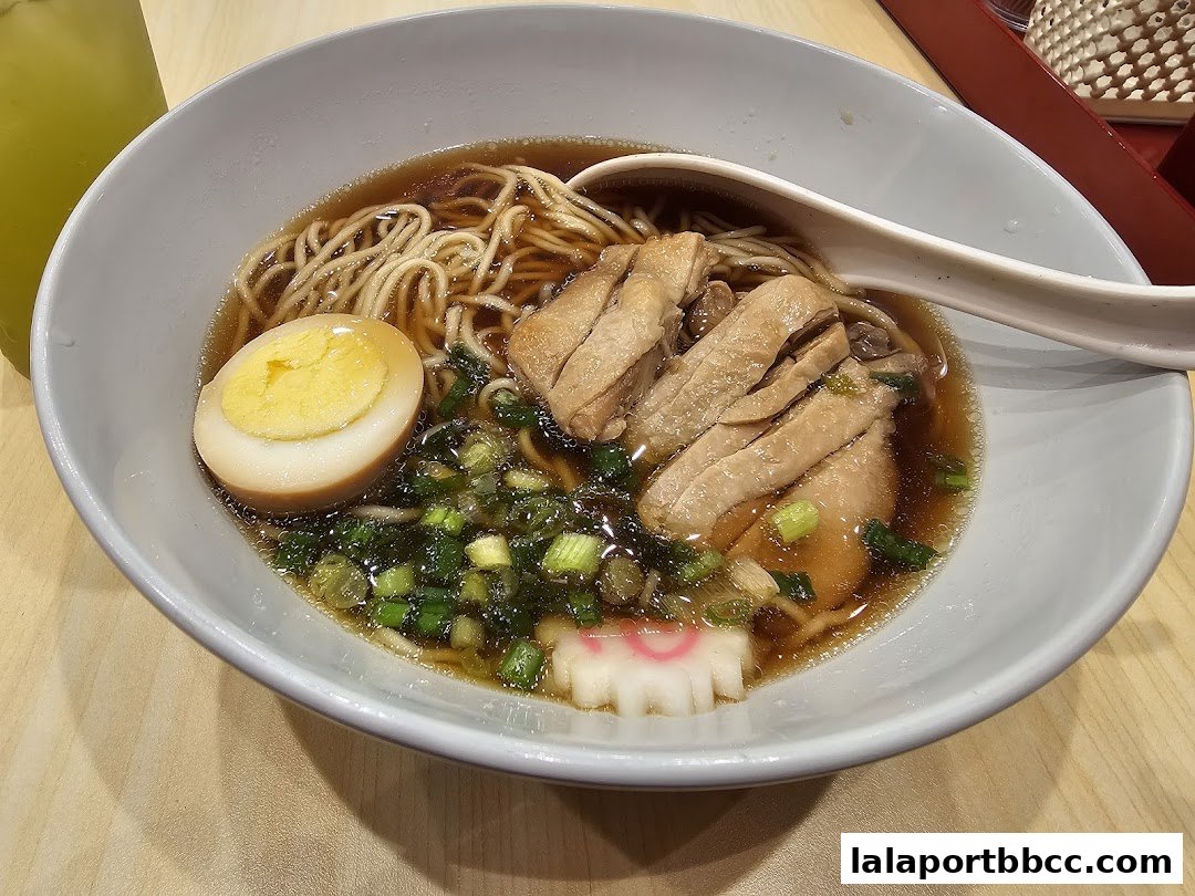 A close-up of a delicious bowl of ramen with chicken, egg, and green onions.