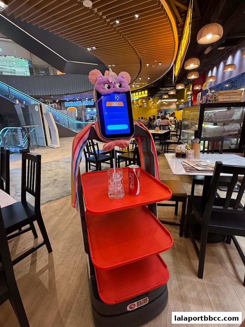 A robotic server with a cute unicorn design is ready to serve drinks in a restaurant.