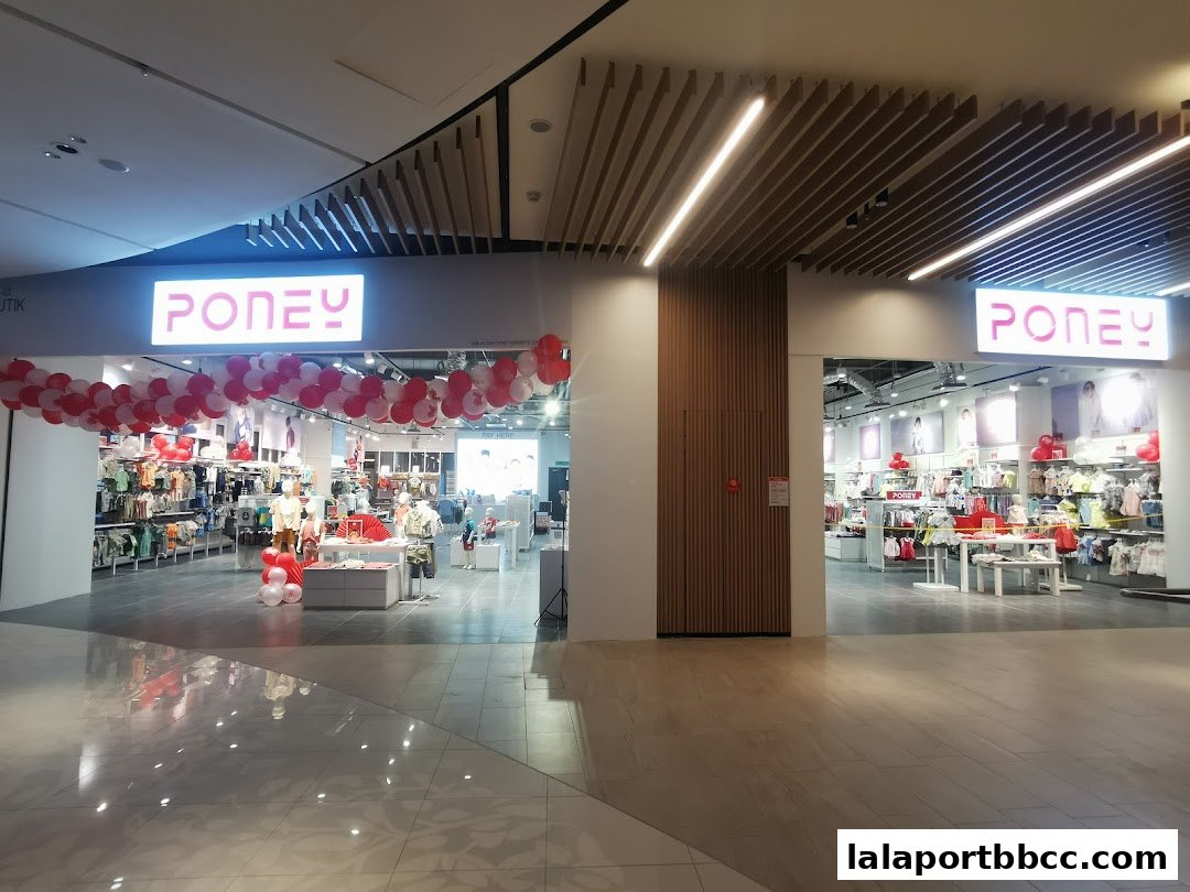 The Poney store entrance decorated with red and white balloons, showcasing children's clothing.