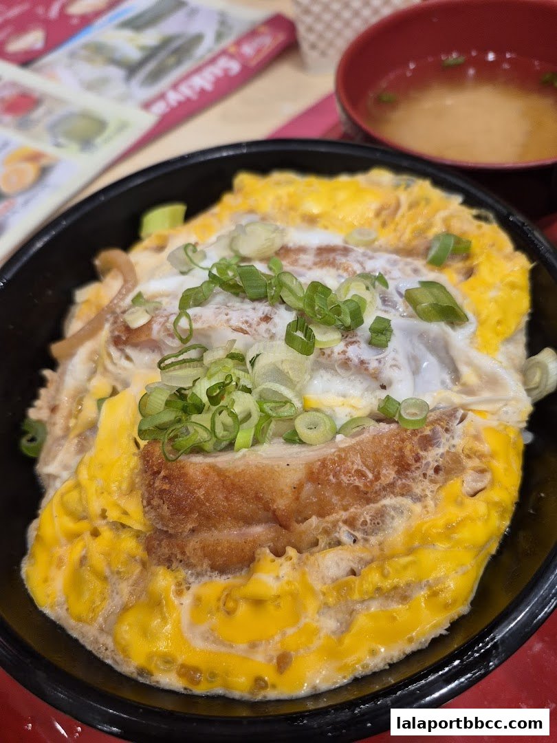 A close-up of a delicious Japanese rice bowl dish with fried chicken and egg.