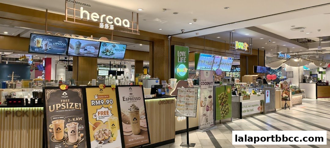 A food court with various beverage stalls, including Herbaa and Boost, offering drinks and snacks.