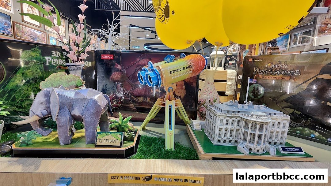 A display of intricate 3D puzzle models including an elephant, binoculars, and the White House.
