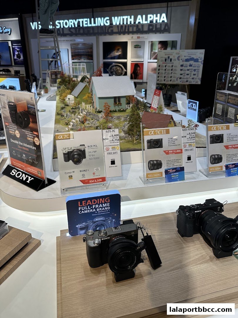 Sony Alpha camera display featuring various models and promotional materials.