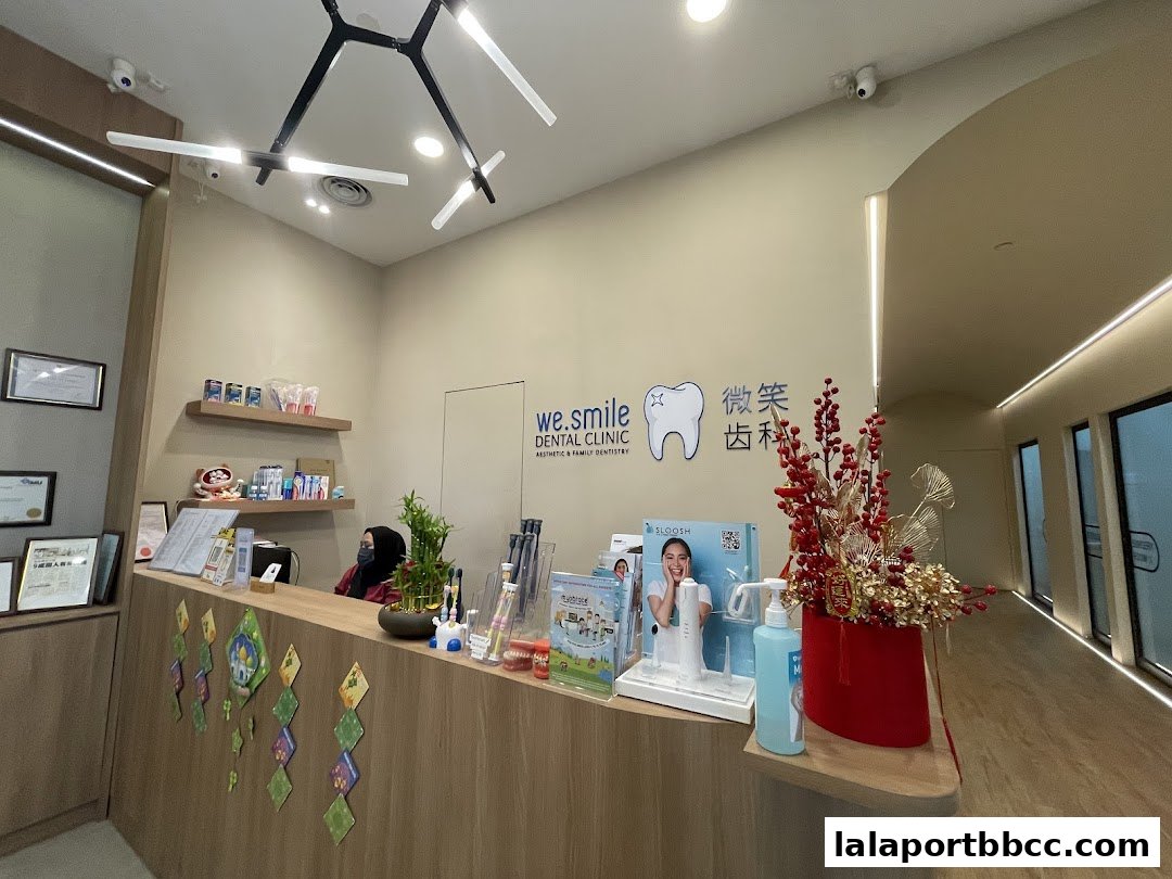 The reception area of WeSmile Dental Clinic with a wooden counter, dental products, and decor.