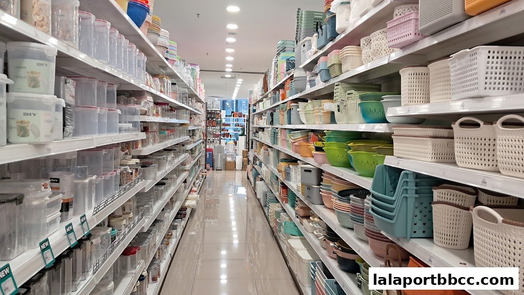 A wide aisle in a store filled with shelves of various storage containers and baskets.