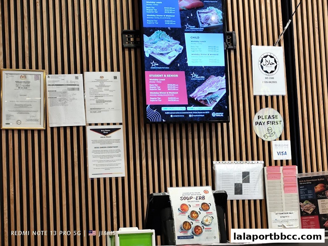 A wall display with various certifications, menus, and payment information for Seoul Garden.