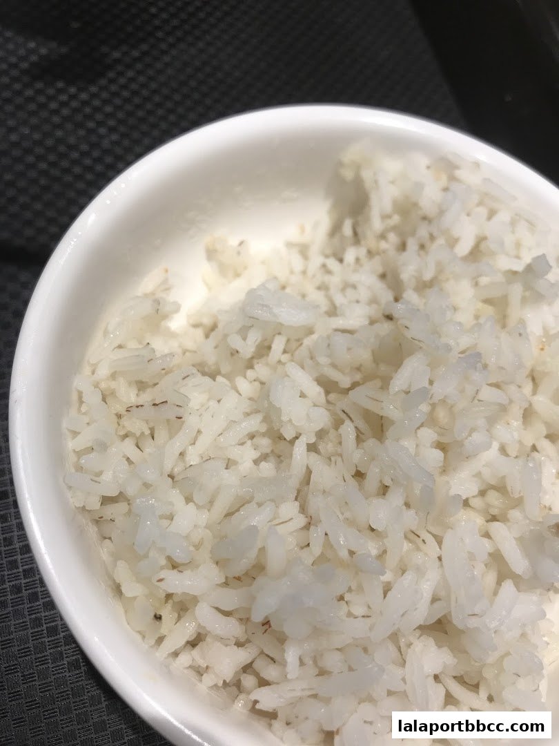 A close-up shot of a bowl filled with fluffy white fried rice.