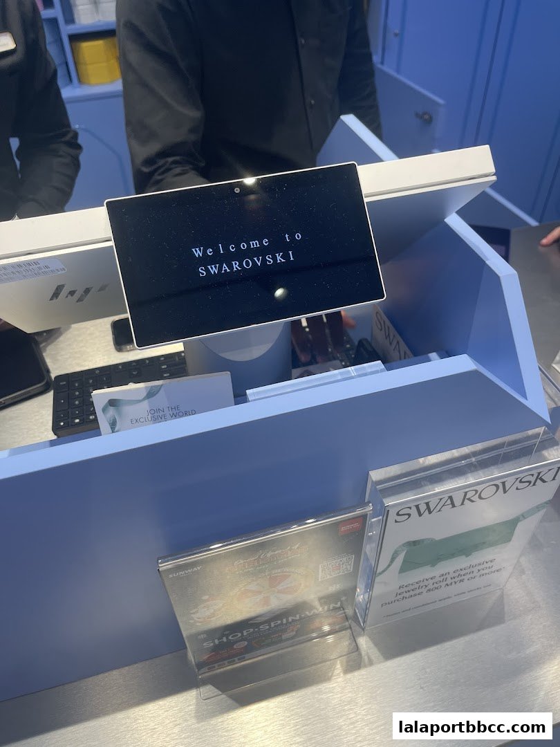 A welcome screen at the Swarovski store counter with promotional materials.