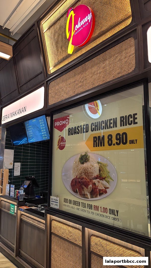 Johnny Chicken Rice shop front with a prominent display of roasted chicken rice.