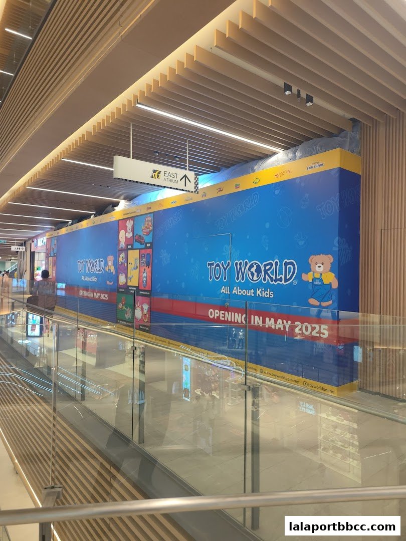 A large blue banner for Toy World, announcing its opening in May 2025.