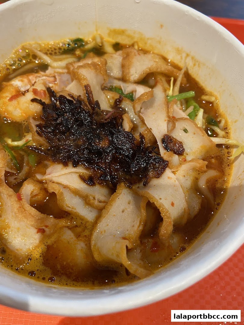 A close-up shot of a delicious bowl of Laksa with generous toppings.