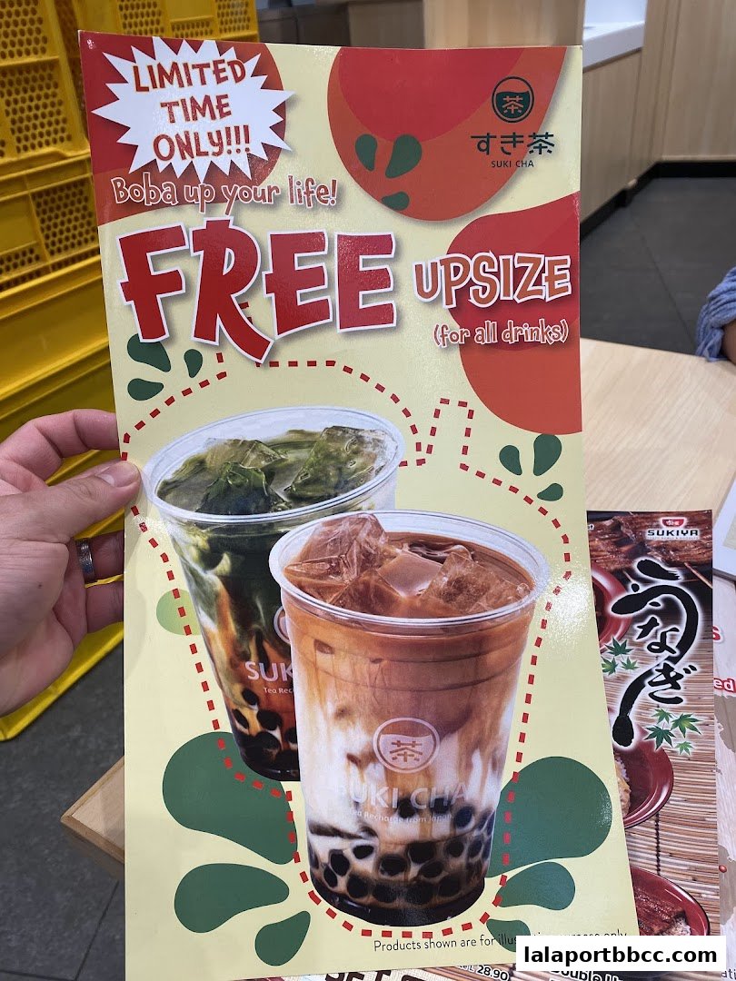 A promotional flyer for Suki Cha offering a free drink upsize.